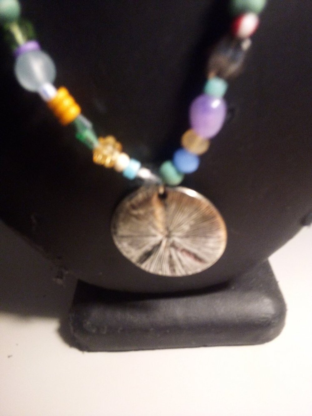 PEACE  PENDANT ON A COLORFUL BEADED NECKLACE